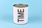 Concept of lack of time showing a tin can with white label and word `Time` on blue background