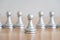 Concept of leadership, think different and recruitment employee. Pawn chess leading others on wooden table. Leadership skills