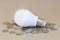 Concept of LED bulb with coins for choice of saving technology