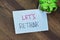 Concept of Let\\\'s Rethink write on sticky notes isolated on Wooden Table