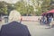 Concept loneliness, retired elderly woman sitting in a public park. Copy space