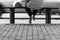 The concept of a long wait before departure. A woman is sitting on a bench with bags and waiting for transport at the bus station