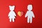 Concept of love with boy, girl and gummy heart candy on red background