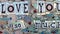 Concept of love. Urban art of I love you words with colorful montage shape on multicolored background. Wall graffiti.