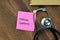 Concept of Marfan Syndrome write on sticky notes with stethoscope isolated on Wooden Table