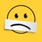Concept of melancholy with an emoticon usually expressing joy, made sad by an inverted smile.