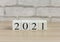 The concept of a New year.A combination of numbers that make up the new year 2021.Wooden cubes with numbers on the table