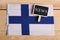 concept news feeds - Breaking news, Finland country& x27;s flag, blackboard and the text News