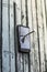 Concept of obsolete technology:mobile phone nailed to the fence a large nail