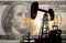 Concept oil and dollar. Installation for drilling a pump oil against a background of one hundred dollars a banknote, money