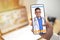Concept of online medical services, shows smartphone app with Asian male doctor smiling, telehealth, telemedicine video call