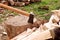 The concept of the onset of cold weather and fuel harvesting. An axe on a wooden block against the background of chopped firewood