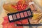 The concept of a palette of autumn paints in a stick of shadows shade nude for makeup. Flat lay.