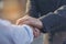 Concept partnership. Partners who is businessman and customer are touching hands promise to be honest in business. Hand shaking