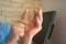 Concept photo of pain or spasm in thumb. Man hold thumb with palm of the other hand, which muscles of which are spasming or aching