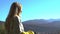 Concept portrait of young attractive blonde girl in mountains looking for the beatiful countryside 4k