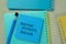 Concept of Positive Attracts Positive write on sticky notes isolated on Wooden Table