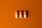 The concept of positive. Three orange capsules on an orange background.