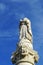 The concept of prayer and faith depicted on an ancient stone sculpture with folded hands