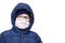 Concept of quarantine. A boy in winter clothes and a white respiratory medical surgical mask as a protection from