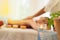 Concept relaxation and healthy spa.Blurred Asian young woman receiving salt with massage hand in spa salon, focused on