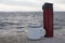 Concept of reusable accessories. friendship white mug and red thermos, who sit on the shore and admire the beauty of nature by the