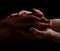Concept of salvation. Hands of two people rescue, help. Helping hand, support. Isolated arm on black, charity. Devoted