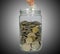 Concept of saving money, putting money into money jar, increase savings