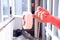 The concept of self-repair. A man`s hand holds a masking tape on the background of an open balcony window, close-up