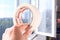 The concept of self-repair. A woman`s hand holds a masking tape on the background of an open balcony window, close-up