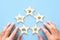 concept of setting a five star goal. male hand arranging shopping service icons over wooden blue background.