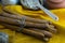 Concept shot of spice bread sticks with a wooden spoon on the wood table, oatmeal and a skein of bag thread