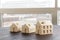 Concept shot: three differently sized wooden models of houses on an architects table