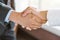 Concept signing business contract, Close up above view of Businessman and client shaking hands after contract agreement done deal.