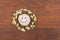 Concept, smiley stone and daisies lying on a wooden surface.