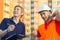 Concept, smiling group of builders in hardhats with clipboard