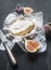 Concept snacks for wine, camembert cheese, fresh sliced figs, vintage table knife, on rustic wooden dark background