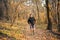 The concept of sport and a healthy lifestyle. A young slender man in sports clothes is engaged in Jogging in the autumn forest or