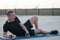 Concept: sport. Man lying on the mat. relaxed resting between sets of exercises. Outdoors at dusk. Smiling