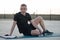 Concept: sport. Man sitting on the mat. relaxed resting between sets of exercises. Outdoors