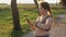 Concept of sports and fitness. Young plus size woman using fitness tracker while jogging outdoors