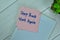 Concept of Step Back Start Again write on sticky notes isolated on Wooden Table