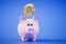 The concept of storing bitcoins. Piggy bank and bitcoin coin on a blue background. 3D render