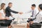Concept of successful handshake of business people in office