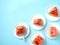 The concept of a summer holiday on a blue background. Pieces of watermelon in a plate, fruit. The view from the top.Flat lay