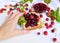 Concept of summer preparation of raspberry jam in a glass vase close-up on a light background with fresh raspberries and a piece o