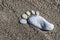 The concept of summer vacation. Footprint on the sand of pebbles, closeup