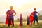 Concept of super family, family of superheroes at sunset