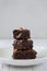 The concept of sweetness, useless food. Pyramid of three pieces of chocolate brownie