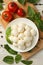 Concept of tasty eating with bowl of mozzarella cheese on white wooden background